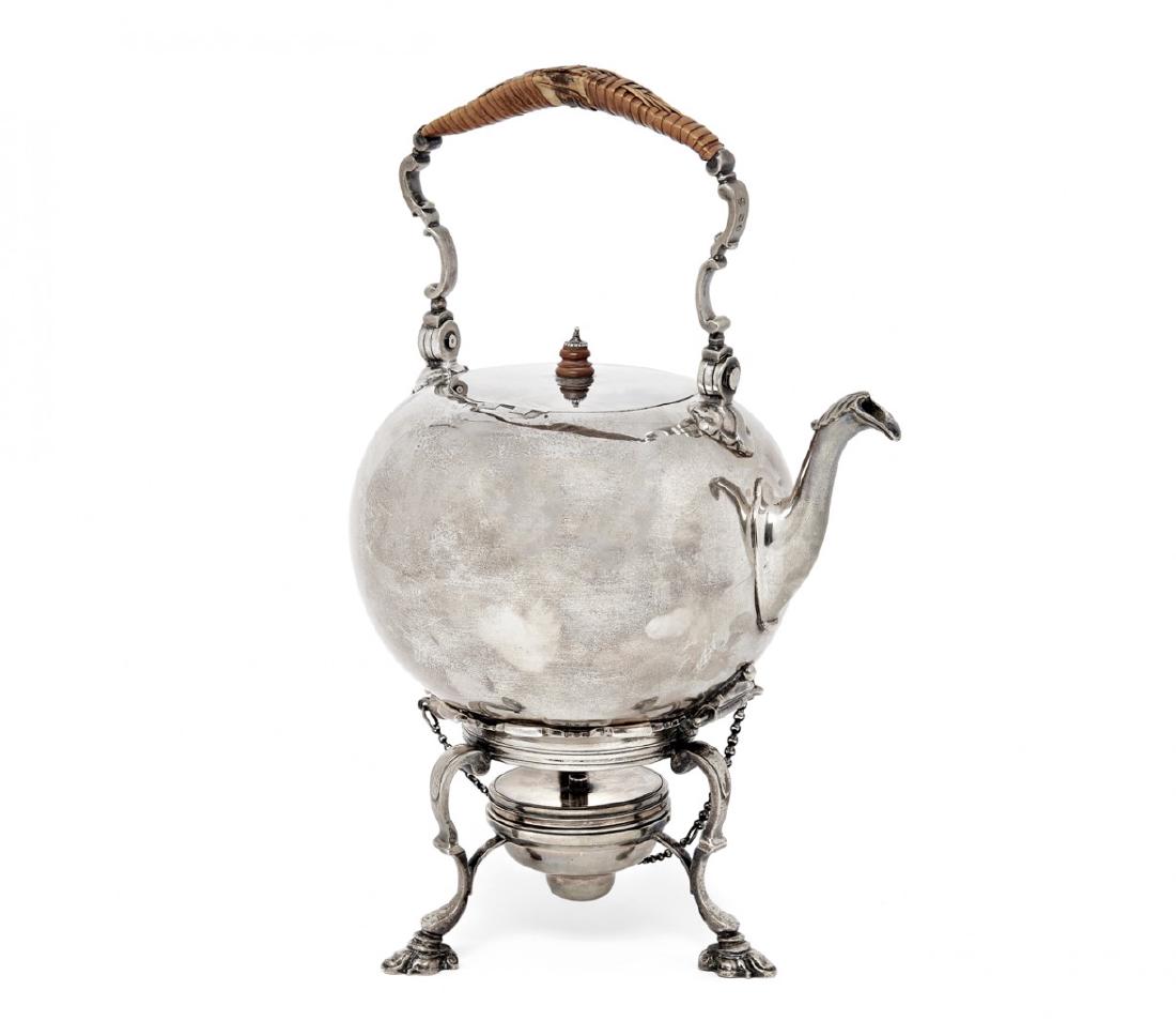A SILVER SAMOVAR, CHARLES STUART HARRIS: London 1874/75 Tripod on contoured foot, the body smooth, hinged, folding contoured handle with holder in woven straw, smooth lip terminating in an acanthus leaf. Slightly damaged. 1448 g Height 8.66