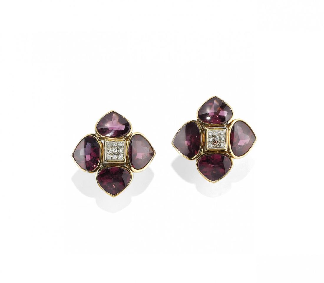 PAIR OF GARNET AND DIAMOND EAR CLIPS, ANTONINI MILANO: PAIR OF GARNET AND DIAMOND EAR CLIPS, ANTONINI MILANO in yellow gold depicting a flower with buff top garnet petals centering pavé-set diamonds weighing approx. ct 0,30. Signed Antonini. In original