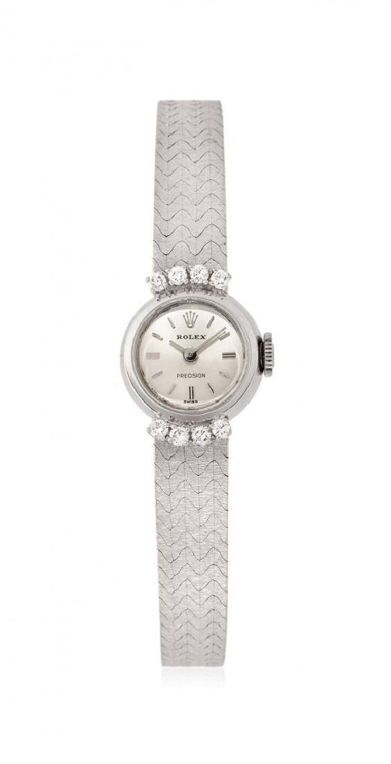 WHITE GOLD LADYâ€™S WRISTWATCH ROLEX PRECISION, 70S: WHITE GOLD LADYâ€™S WRISTWATCH ROLEX PRECISION, 70S Two bodyÂ circular 18K white gold case, bezel sets up and down with diamonds,Â snap on back, Rolex crown. Incorporated 18K white gold brace