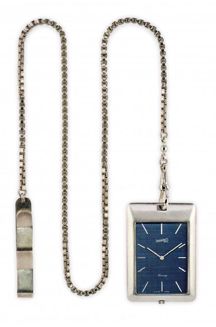 DRESS POCKET WATCH SIGNED EBERHARD, '70S: DRESS POCKET WATCH SIGNED EBERHARD, '70S Two body rectangular polished steel case, snap on back,Â n. 23353 515, winding crown at 6 oâ€™clock. Accompanied by a fob chain signed Eberhard. Blued m