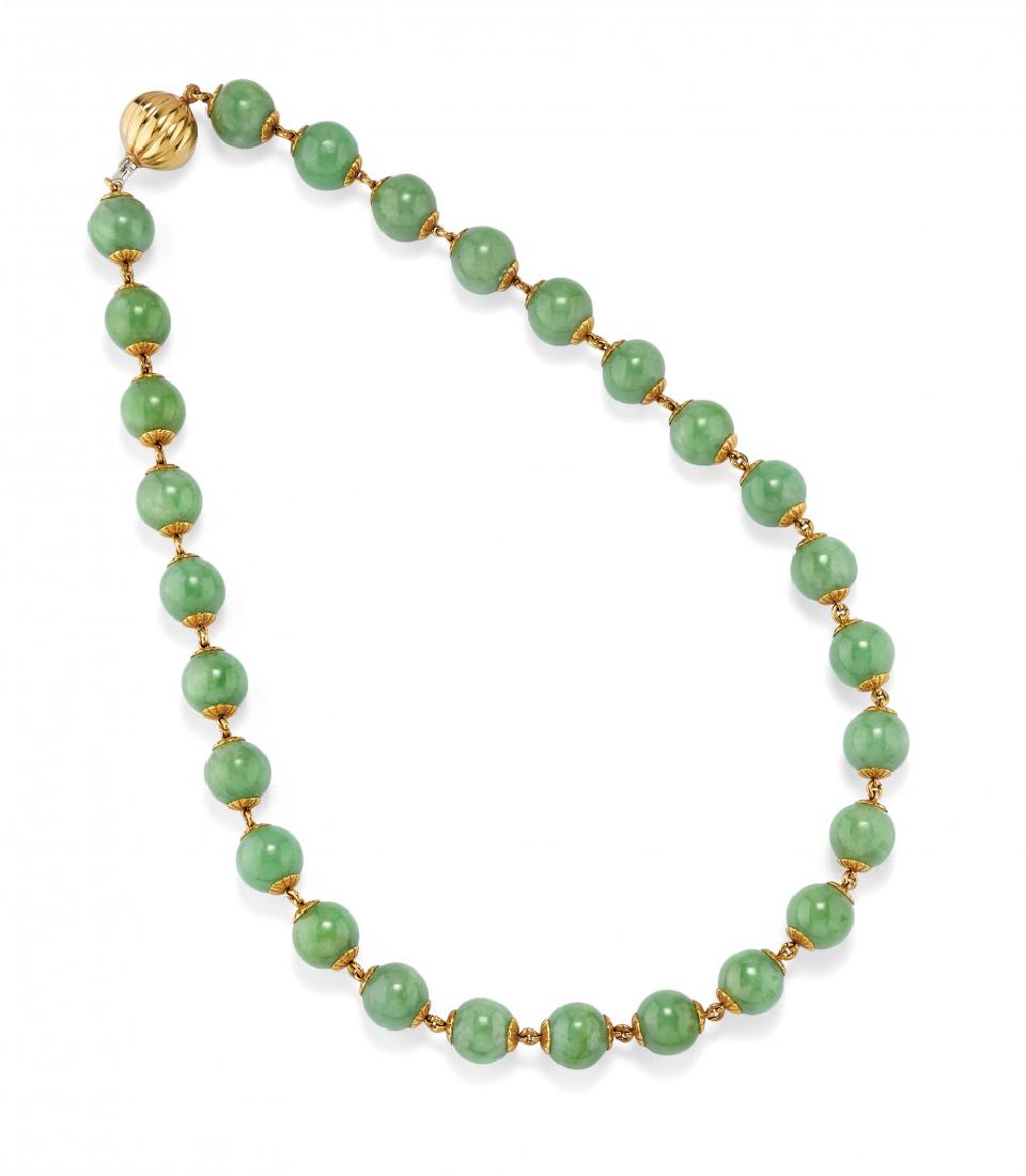 GOLD AND NEFRITE NECKLACE: GOLD AND NEFRITE NECKLACE designed as a strand of round nephrite beads measuring 12.00 mm set in yellow gold.