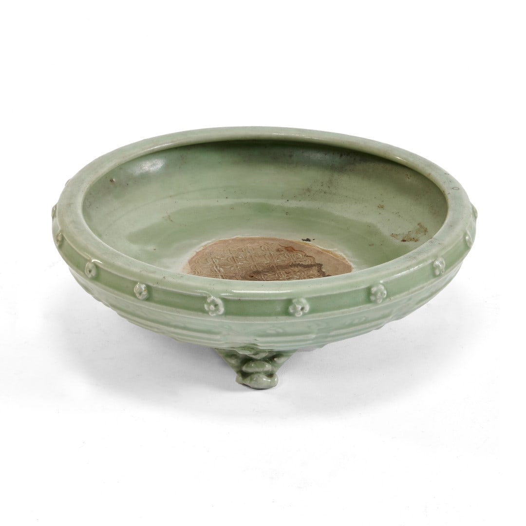 Tripod censer China, Ming dynasty, 14th-15th century: Longquan ceramic with celadon glaze, the vessel standing on three feet shaped like mythological animal heads, the body with Eight Trigrams in relief amidst incised floral arabesques, the outside of th