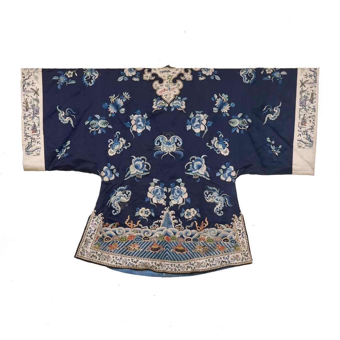 Woman's robe China, Qing dynasty, 19th century: Silk worked with polychrome embroidery, blue ground with floral decoration, the lower section with stylised waves and auspicious symbols, the white ground borders with scenes of small figures in the l
