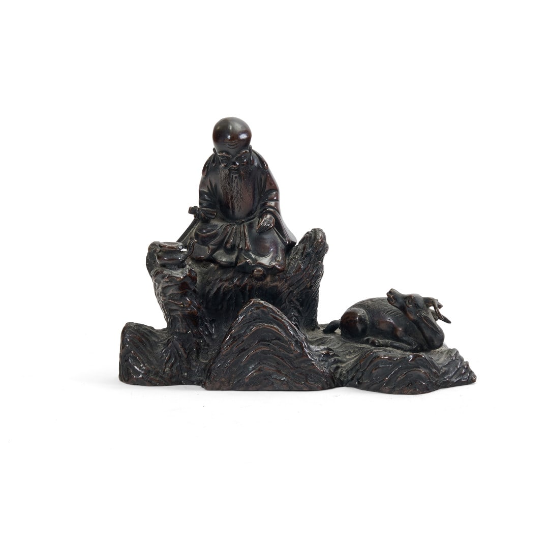 Incense burner China, Ming dynasty, 16th-17th century: Bronze, the group depicting Shoulao seated on a rock, a calligraphic scroll in his right hand, a pouring nearby, and lower down a deer, an animal also a symbol of longevity with which the deity is