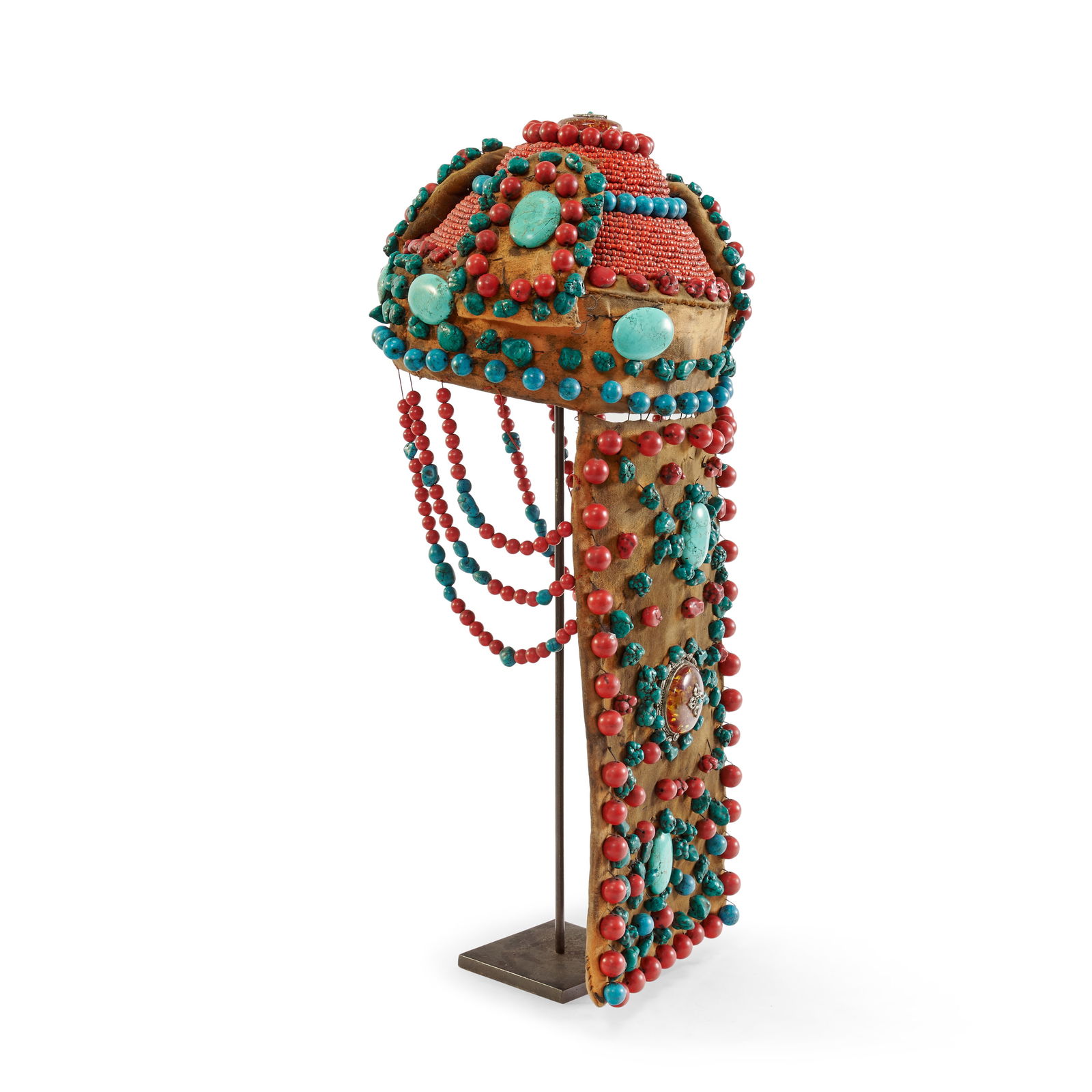Cerimonial headdress Tibet, 20th century: Leather with an exuberant decoration of turquoise, red coral, metal and amber. 20.5 x 9.8 in.