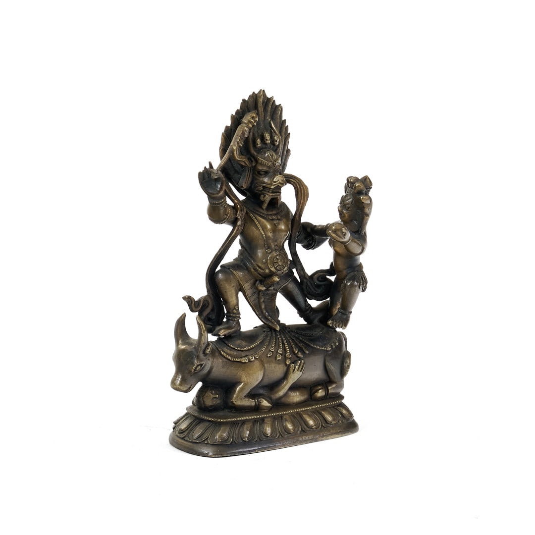 Outer Yama Dharmaraja China, Qing dynasty, 19th century: Bronze, the deity and his consort riding on the back of a bull crushing a figure, all on a lotus-shaped base. Despite his terrifying appearance, amplified by his buffalo-headed face and wrathful