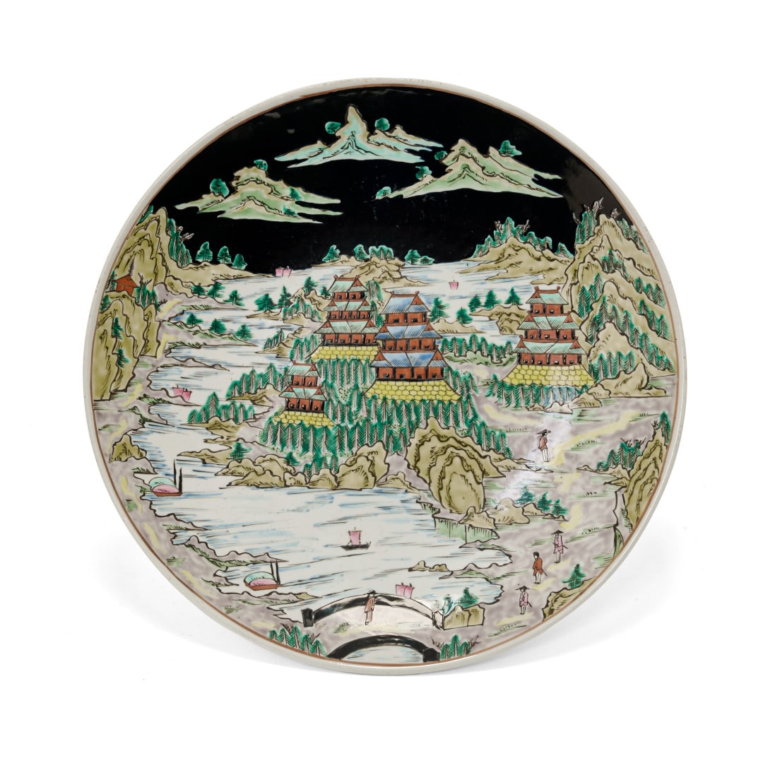 Large dish China, 20th century: Porcelain painted with polychrome enamels, decoration of a lake landscape with mountain peaks, pavilions, boats and small figures, mark to the centre of the base. 2 x 15.7 in.