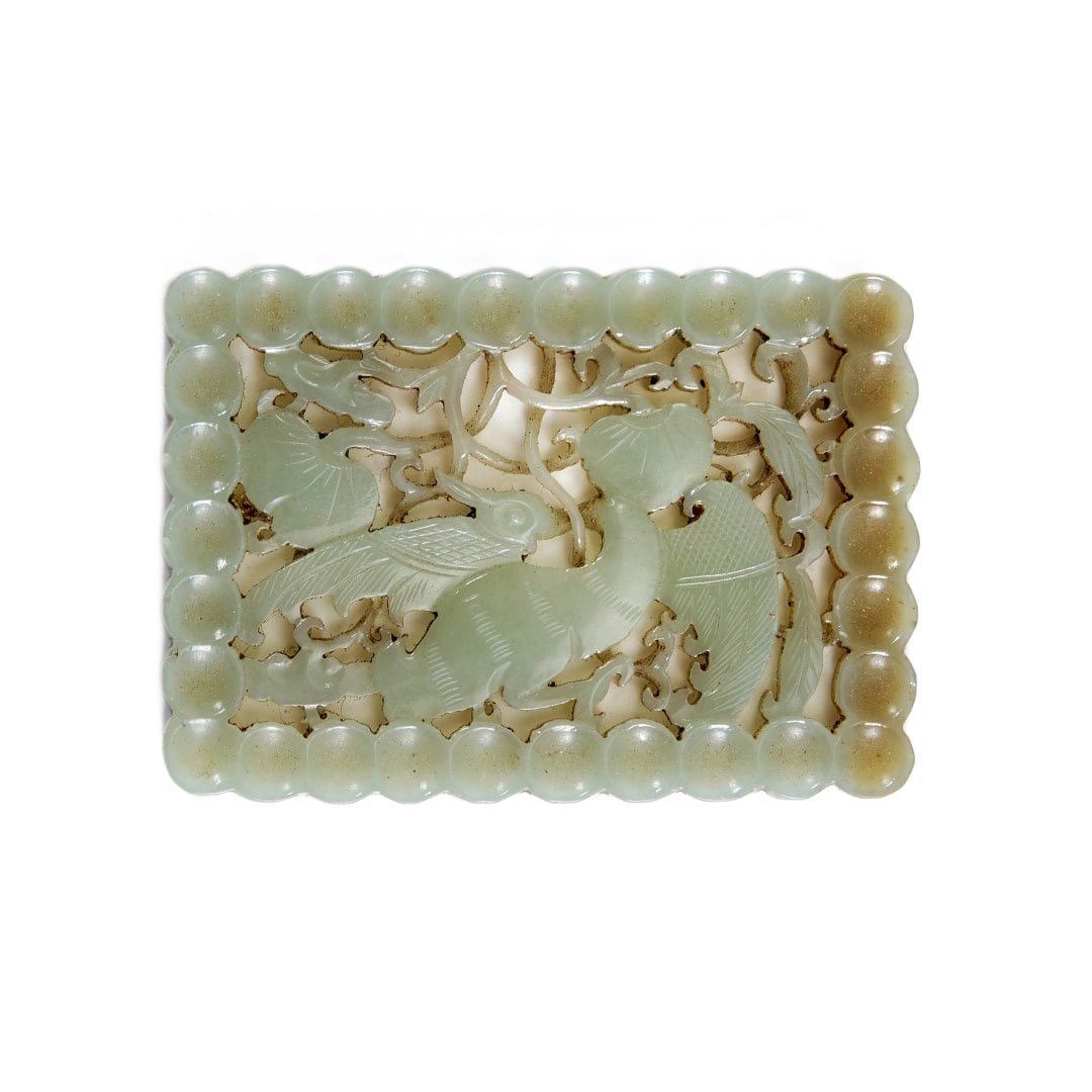 Plaque China, 20th century: Pale green jade, openwork decoration of a bird amidst vines. 2 x 2.8 in.