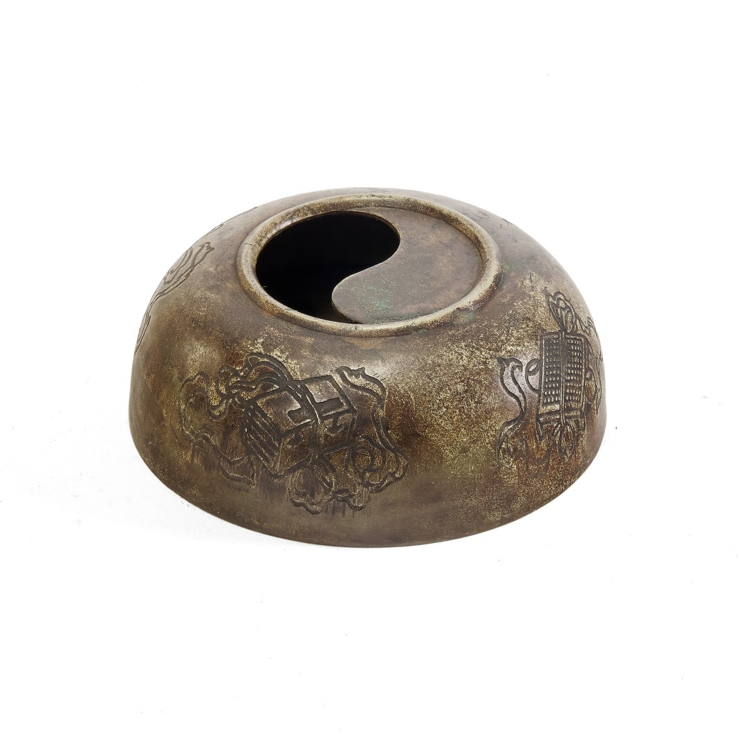Brushwasher China, 20th century: Bronze, the exterior wall with incised auspicious objects, the opening modeled as a yin-yang symbol. 1.6 x 3.5 in.