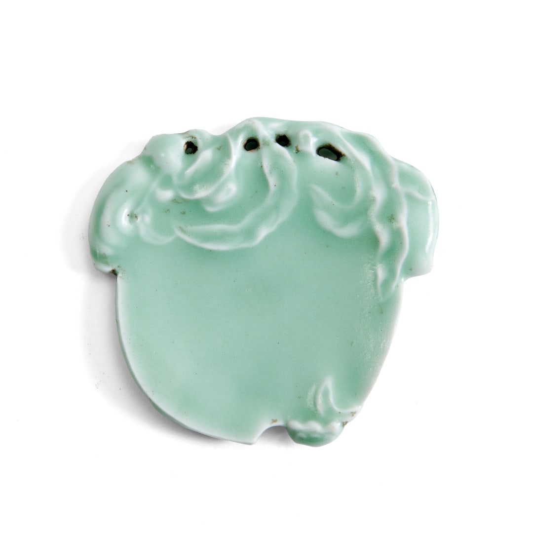 Brushwasher China, 20th century: Celadon-glazed porcelain, modeled as a peach, apocryphal Qianlong mark to center of base. 3.2 x 3.3 in.