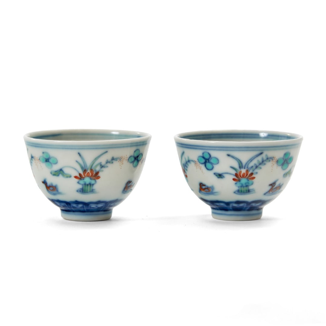 Pair of small bowls China, 20th Century: Porcelain painted with polychrome enamels, the outside of the wall with a decoration of flowers and ducks, (Qinghua zhenping, "clear and beautiful precious object" mark to the center of the base of bo