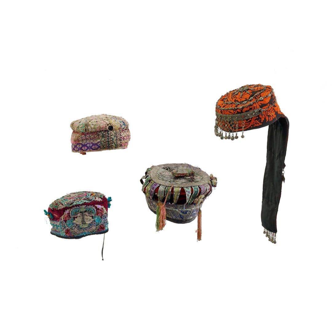 Four hats Afghanistan and China, 20th century: Fabric and metal. 19.3 x 6.7 in. the largest