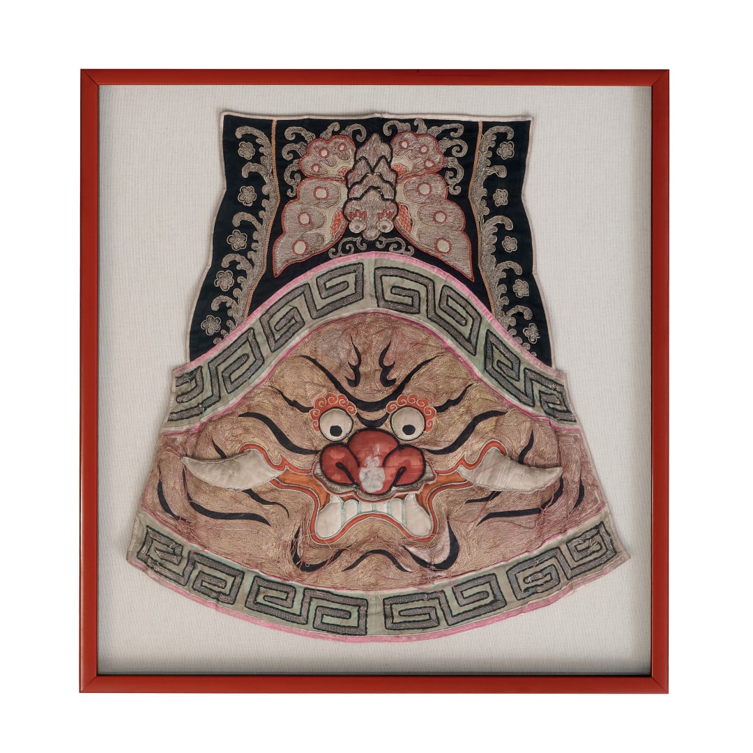 Fabric Tibet, 20th century: Partially padded polychrome silk, depicting a demonic mask within a geometric border, a butterfly at the top, wooden frame and protective glass. ?????Defects. Measures include the frame. 28 x 26.4 in.