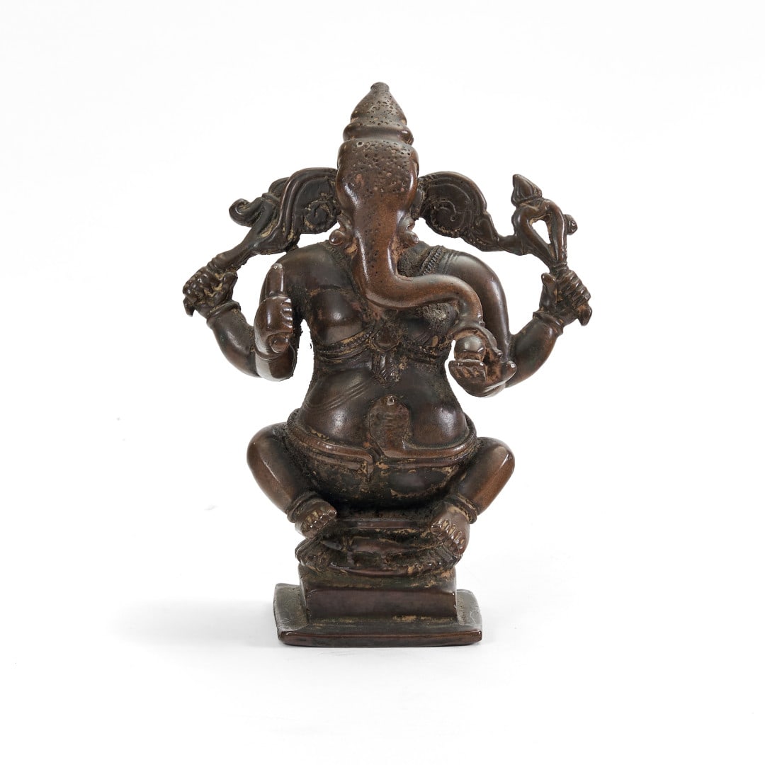 Ganesha India, 19th-20th century: Copper alloy, the deity depicted seated on a pedestal. 5.5 x 4.3 x 2.4 in.