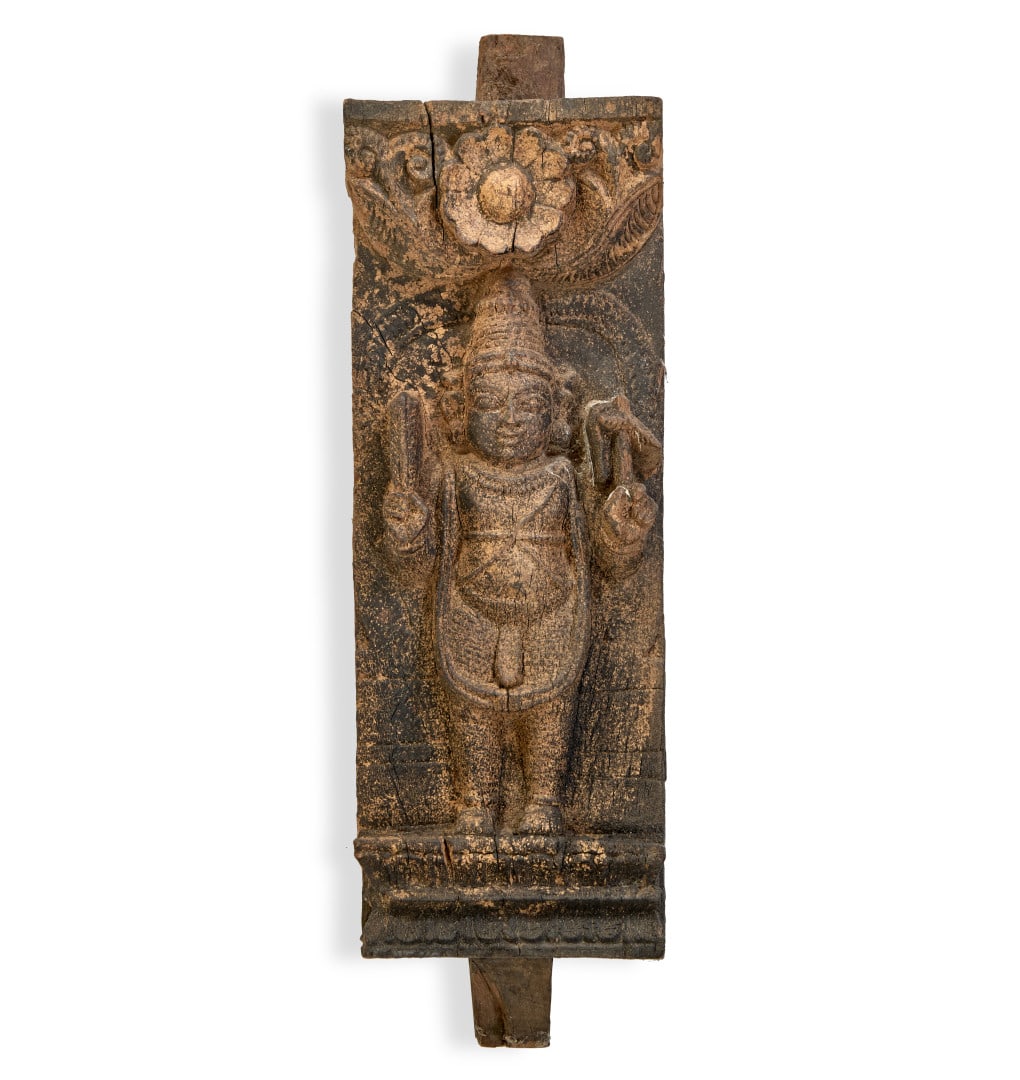 Panel India, 19th-20th century: Carved wood, the front with a standing deity on a lotus flower base in accentuated relief, a corolla at the top, pins at the top and bottom, originally probably part of a piece of furniture. 16.1 x