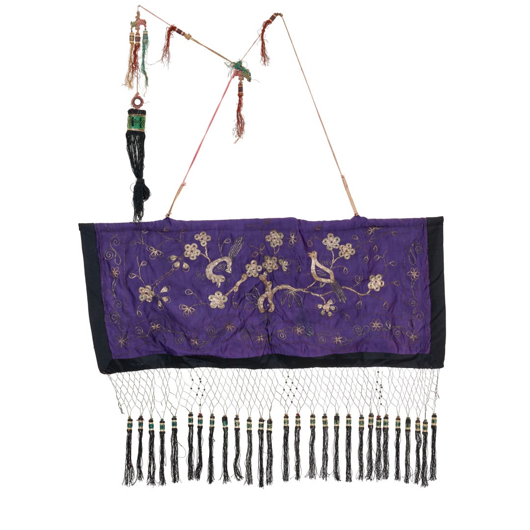Fabric South-East Asia, early 20th century: Purple ground with silver thread embroidery of flowering branches and birds, colored tassels. 40.2 x 33.5 in.