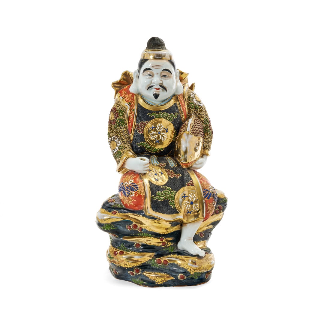 Ebisu Japan, Meiji period: Satsuma-type ceramic painted with polychrome enamels and gold, the protective deity of fishing depicted seated, holding a fish in her left arm. 14.4 x 8.7 x 5.9 in.