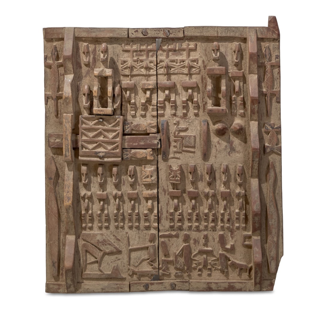 Door Mali, Dogon, 20th century: Carved wood, the front decorated with figures and abstract motifs in accentuated relief. 20.1 x 17.3 in.