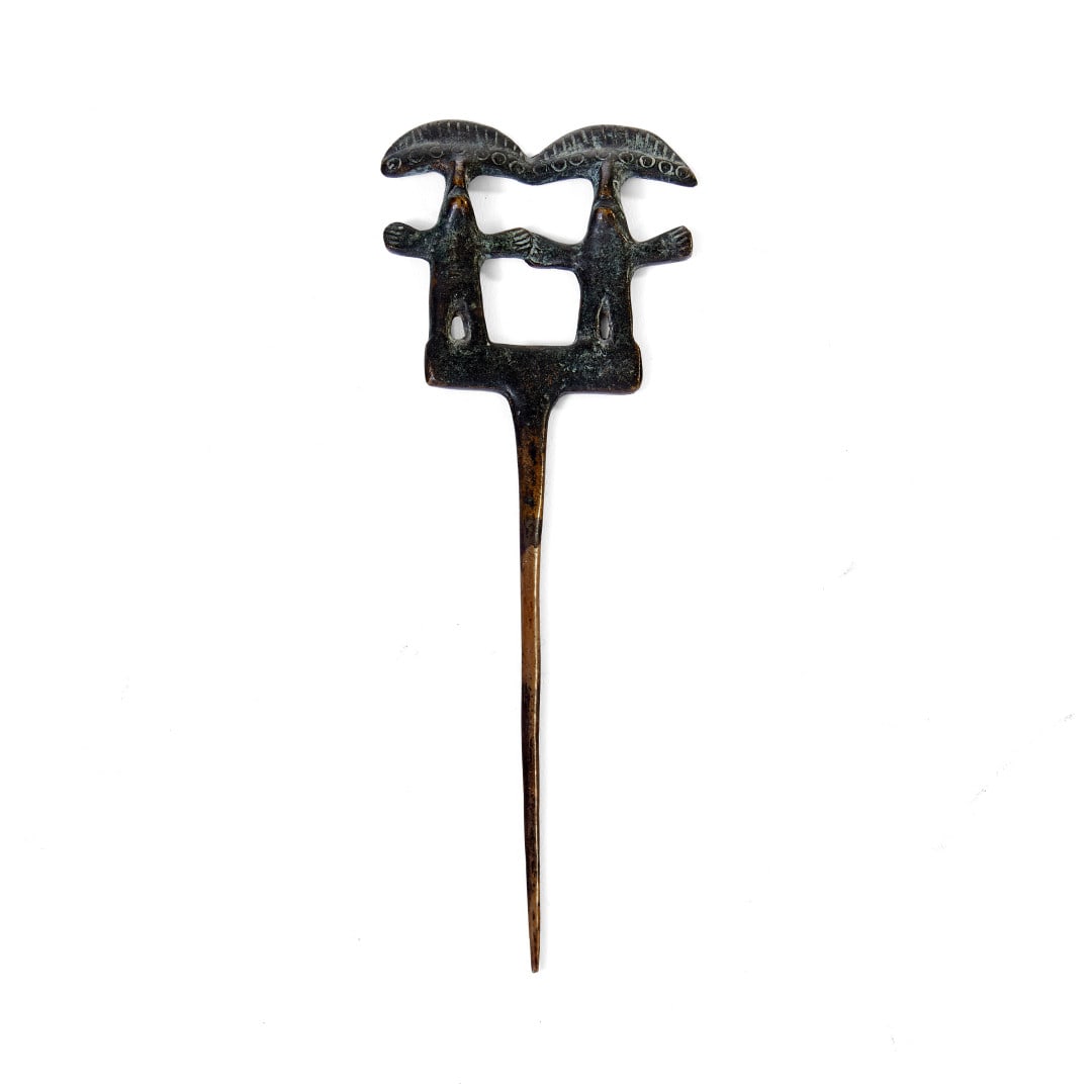 Pin Peru, 1100-1400 A.D.: Bronze, the upper part with two twins. 6.5 x 2.4 in.
