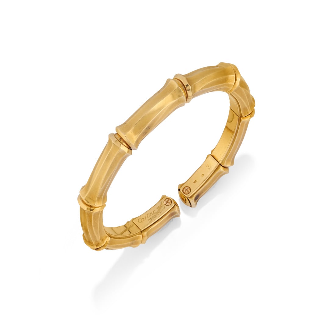BRACCIALE "BAMBÙ", CARTIER - "BAMBOO" BRACELET, CARTIER: in oro giallo a cerchio semirigido composto da elementi di bambù separati e scanalati. Firmato Cartier. Con scatola e controscatola Cartier e certificato originale di Cartier. Gr 55,70 - cm 17,00 x 0