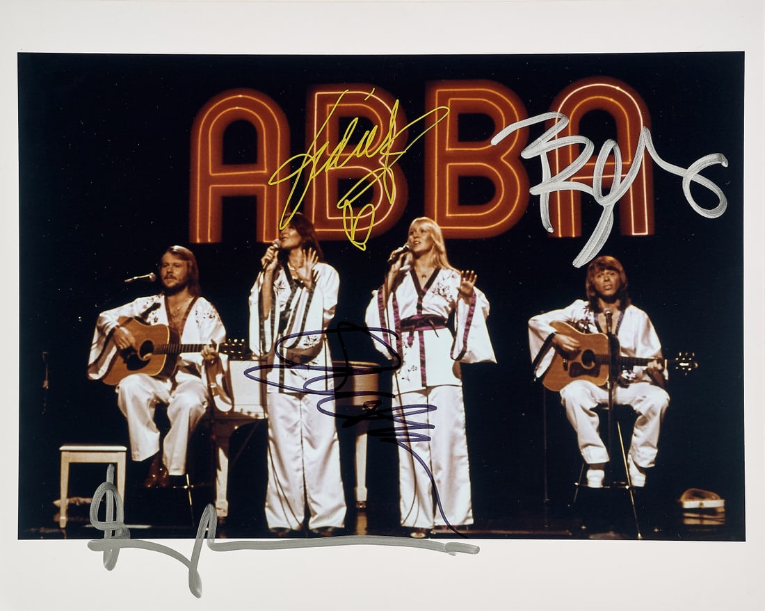 ABBA Signed photographic print: Photographic print depicting the band in concert, signed by all the band's members 7.87 x 9.84 in.
