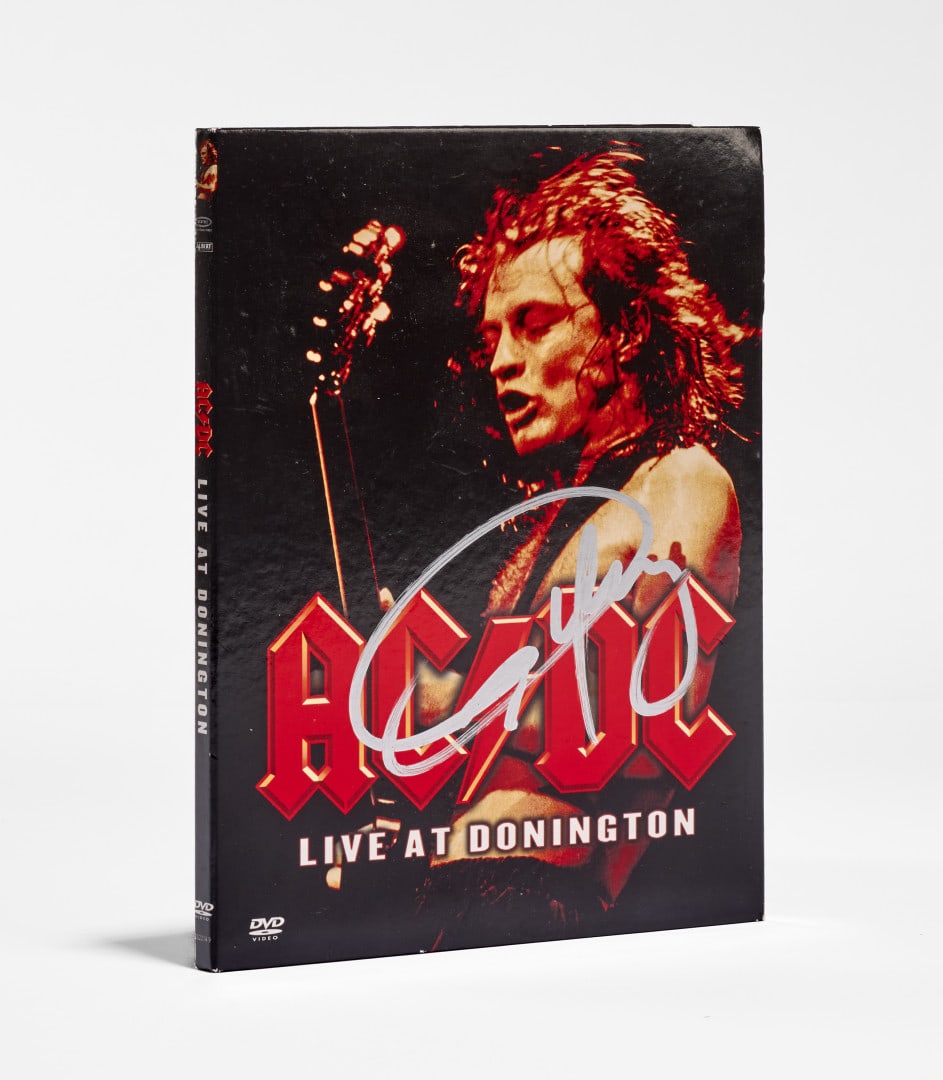 AC/DC DVD “Live at Donington” 1991: Signed by Angus Young, accompanied by an original signed concert ticket from the 1991 Paris show (2)