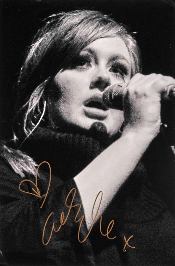 ADELE Signed photographic print: Signed photographic print depicting the artist in concert 11.81 x 7.87 in.