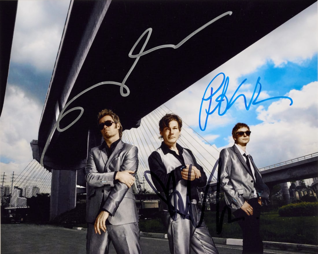 A-HA Signed photographic print: Photographic print showing Morten Harket, Magne Furuholmen and Pål Waaktaar-Savoy, featuring autograph signatures of all members 7.87 x 9.84 in.