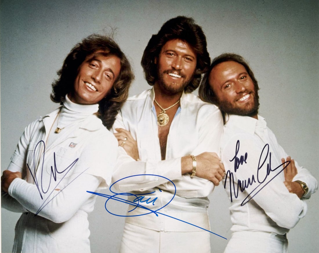 BEE GEES Signed photographic print: Photographic print depicting Barry Gibb, Robin Gibb and Maurice Gibb, featuring autograph signatures of all members 7.87 x 9.84 in.