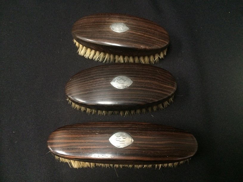 Set (3) ADMIRATION Ebony Grooming Brushes.: This set of three vintage grooming brushes are marked 'NATURAL EBONY PURE BRISTLES STERILIZED JAPAN' on one edge of the brushes and 'ADMIRATION' on the other. They each have a silver plaque stamped ST