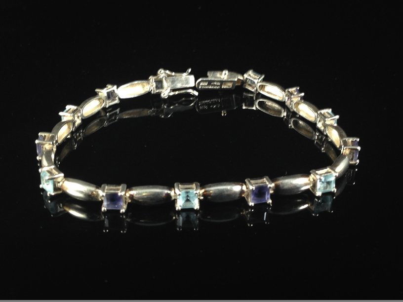 Sterling Silver Amethyst/Aqua Tennis Bracelet.: At 7-3/4" long, this lovely vintage Sterling Silver tennis bracelet has (7) square cut Aquamarines and (6) square cut Amethysts alternating with Sterling bar links. The bracelet has a box style clasp,