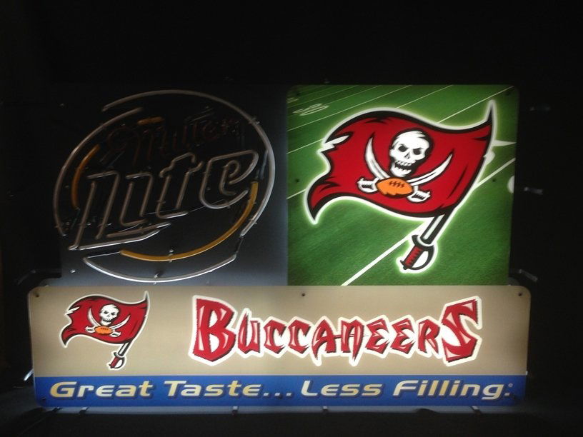 Neon Sign Miller Lite and Tampa Bay Buccaneers: Sign measures approximately 43" across and 27" tall. The sign can stand on it's own, or it can be hung. Fantastic piece of advertising art...neon is broken. Shipping must be arranged by the winning bi