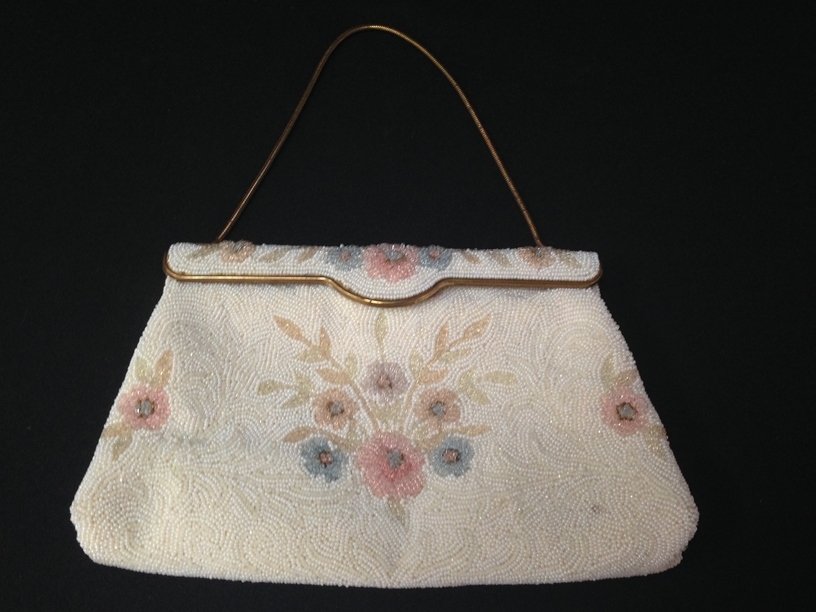 Vintage French Beaded Evening Purse.: This vintage mid-century purse is completely beaded and has a floral design on the front and back with a gold tone trimmed flap closure and a gold tone snake chain handle. The bag is lined with ivory 
