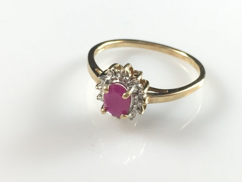 Vintage 10K YG Ruby and Diamond Ring.: The oval cut Ruby set in the center of lovely white Diamonds makes this vintage 10K yellow gold ring a classic. The ring weighs approximately 1.4 grams and will fit size 7. it is in very nice conditio