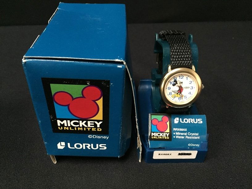 Mickey Mouse Lorus Watch.: This watch seems to be new old stock as it shows no signs of use but it needs a battery. It has a nylon band and a 1-1/4" watch face.