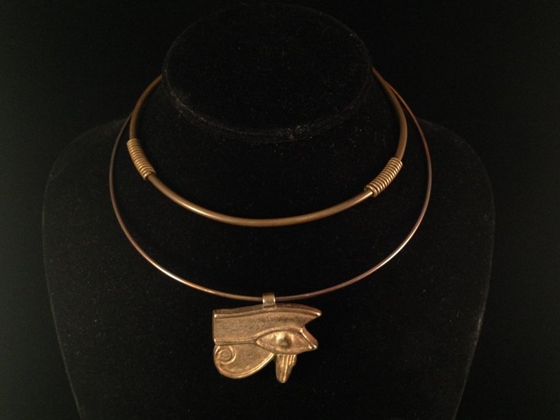 After 1977 MMA King Tut Gold Tone Choker Necklace.: This vintage piece is fashioned after the 1977 MMA King Tut Egyptian Revival 'Eye of Horus' Gold Tone Choker Collar Necklace Pendant. The pendant is an adaptation of the original 'Horus Eye' found amo