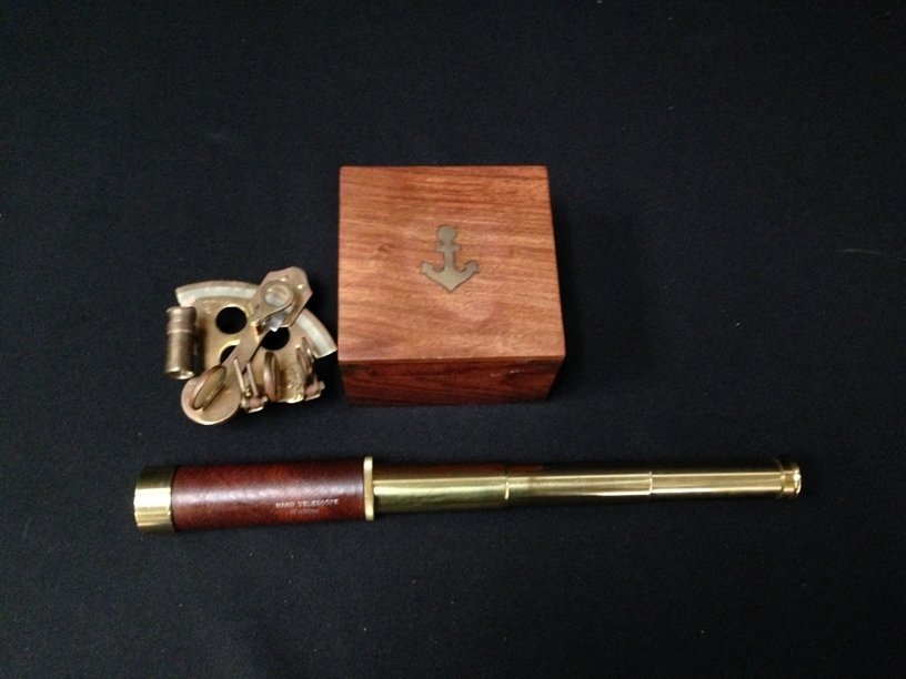 Nautical Brass Sextant in Box and Telescope.: This maritime display sextant is made of brass and is about 5" wide. The sextant comes with its own nautical wood box. The box has brass accents and is about 5" wide and 3.5" tall. The sextant include
