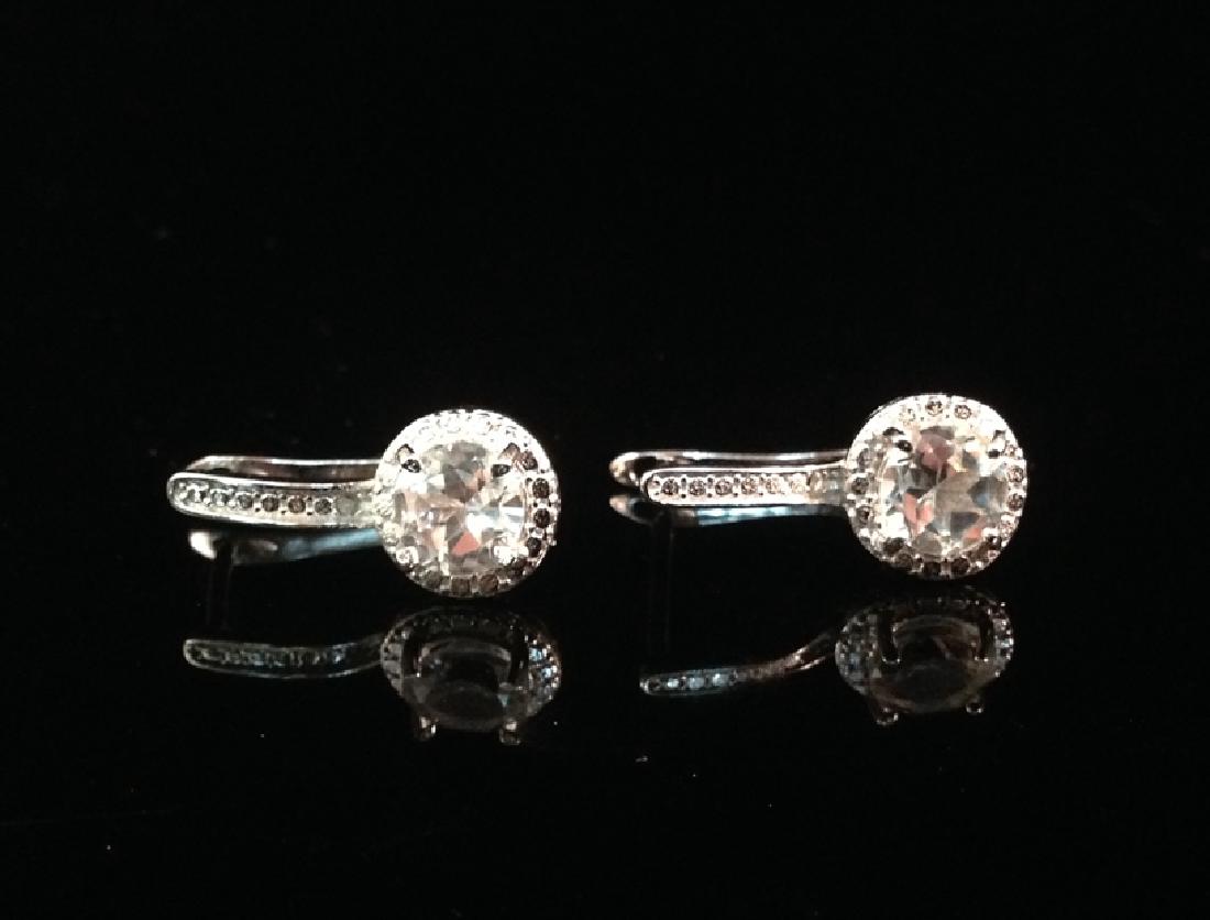 Sterling Silver White Topaz Dangle Earrings NIB.: Vintage inspired, these beautiful platinum clad Sterling Silver dangle earrings are set with 1.44ctw White Topaz gemstones. The earrings are for pierced ears with lever backs and are stamped '925'. Th