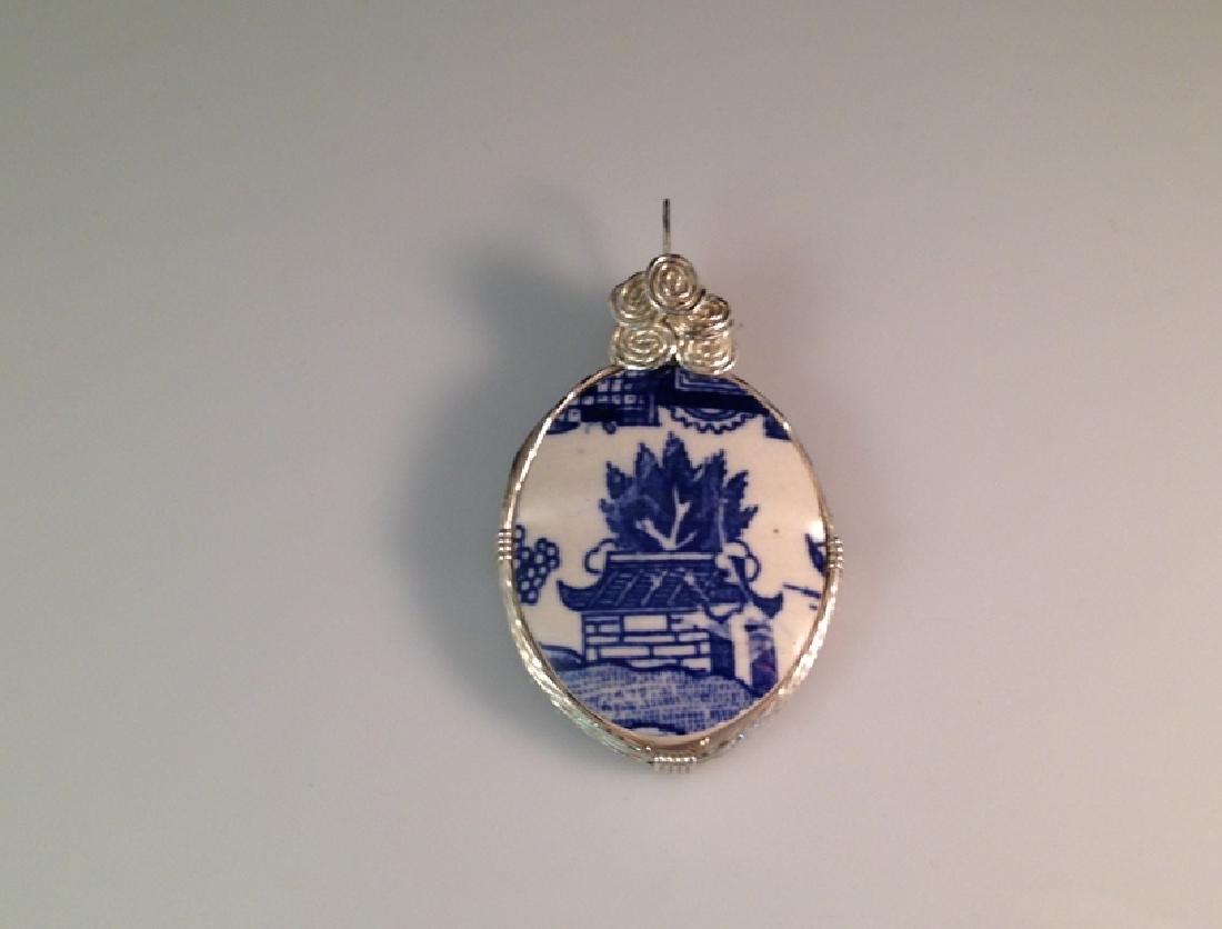 Vintage Flow Blue Sterling Silver Pendant.: We are please to offer this gorgeous hand crafted vintage Pendant Necklace with Flow Blue Pottery set in Sterling Silver. The Flow Blue oval has a design on both sides and is convex/concave and sits s