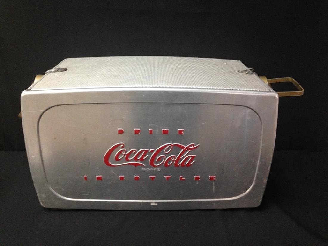 Rare Vintage Coca Cola Bottles Aluminum Cooler: Good Vintage condition with no real dents as shown. The original finger bracket is included. Nice original graphics paint with bottle openers on each end as shown. Rubber lid seal still in place, plea