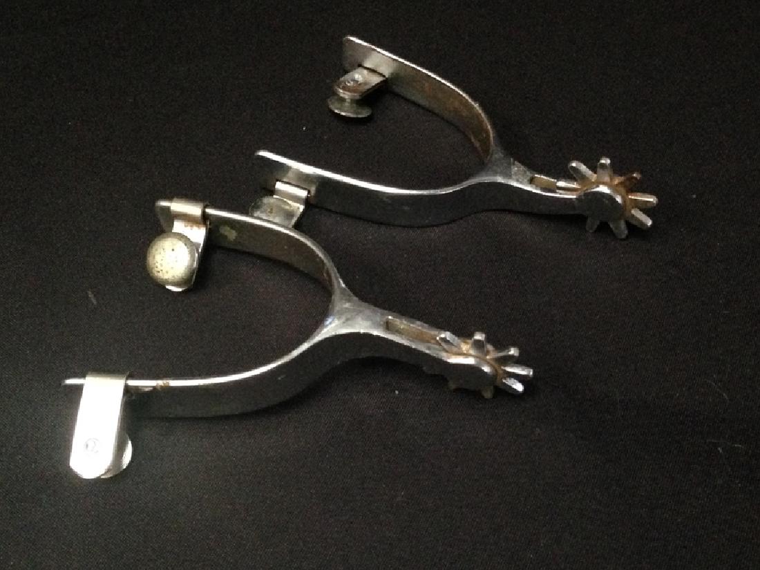 Vintage RODEO Stainless Spurs.: These vintage spurs have seen the heels of many a cowboy boot and are still working. They are stainless steel and signed 'RODEO' and have etched design. They show signs of use, so please see photos fo