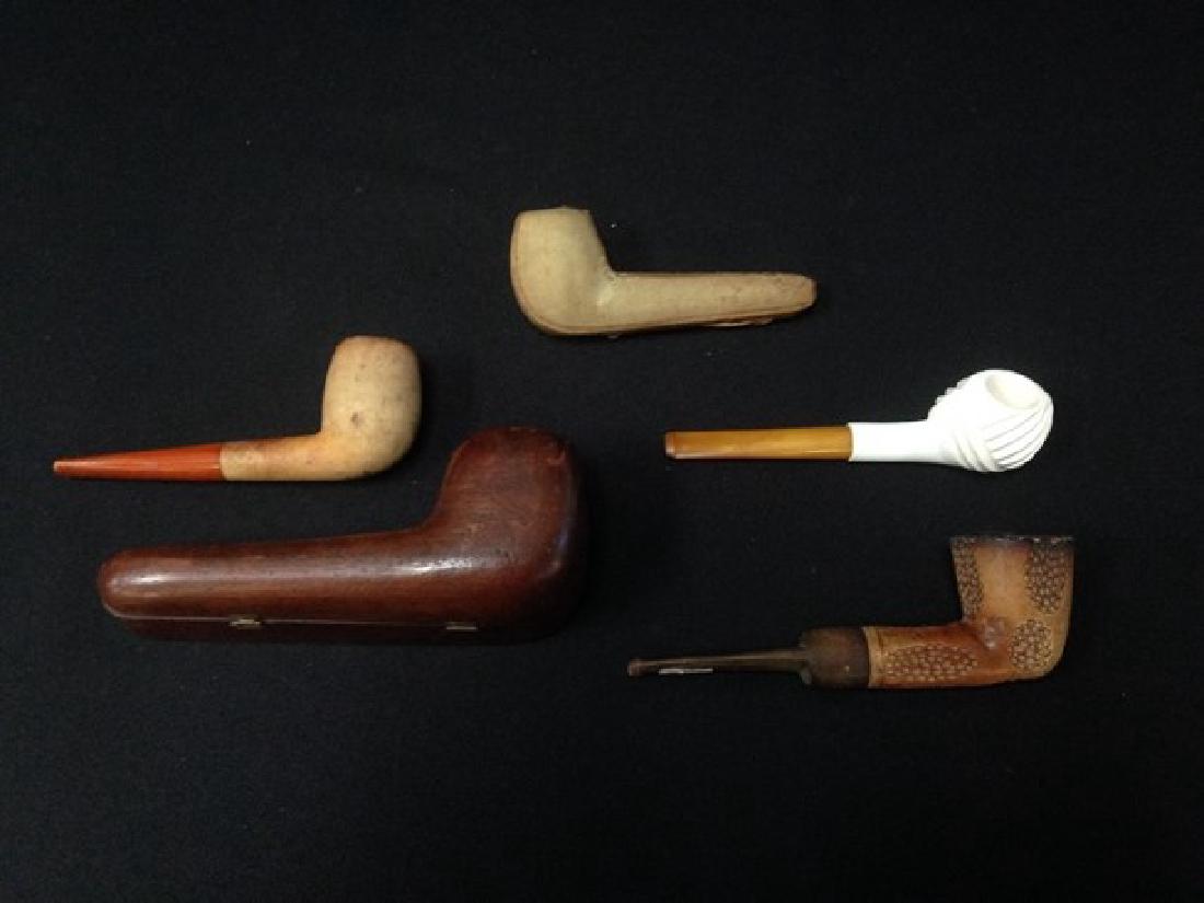 Lot (4) Vintage Meerschaum Pipes.: This lot contains; a block Genuine Block Meerschaum with a tan color and dimple pattern, a white swirl pattern, a white tone pipe with a broken tip, and an unmarked pipe with an etched flower in the s
