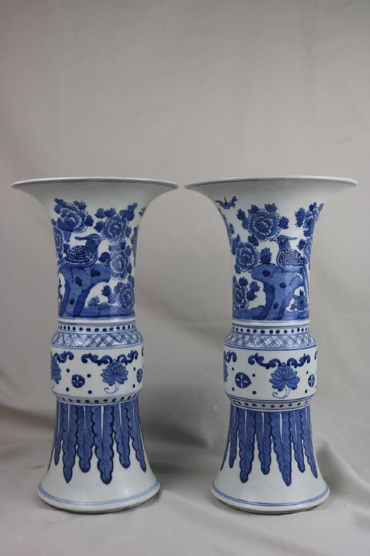 A Pair of Chinese Blue and White Porcelain Beaker Vase: A pair of Chinese blue and white porcelain beaker vase; painted with birds and floral; the base bear a double ring; H: 39 cm, W: 21 cm