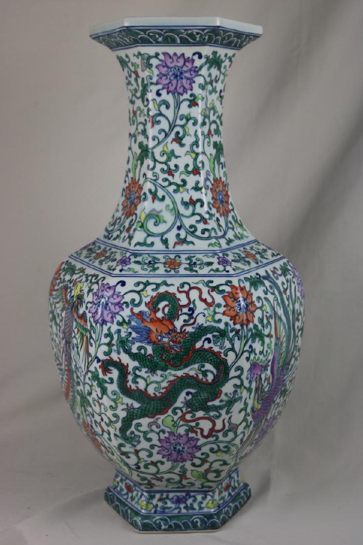 Chinese Doucai Porcelain Vase: Chinese doucai porcelain vase; of hexagon shape; painted with dragon and phoenix surrounded with scrolling floral; six character Yongzheng mark on base; H: 56 cm, W: 31 cm