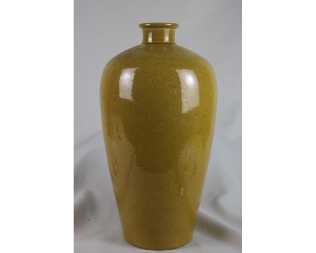 Chinese Yellow Glazed Porcelain Vase: Chinese yellow glazed porcelain vase; painted with low relief dragon; six character Kangxi mark on base; H: 34 cm, W: 18 cm