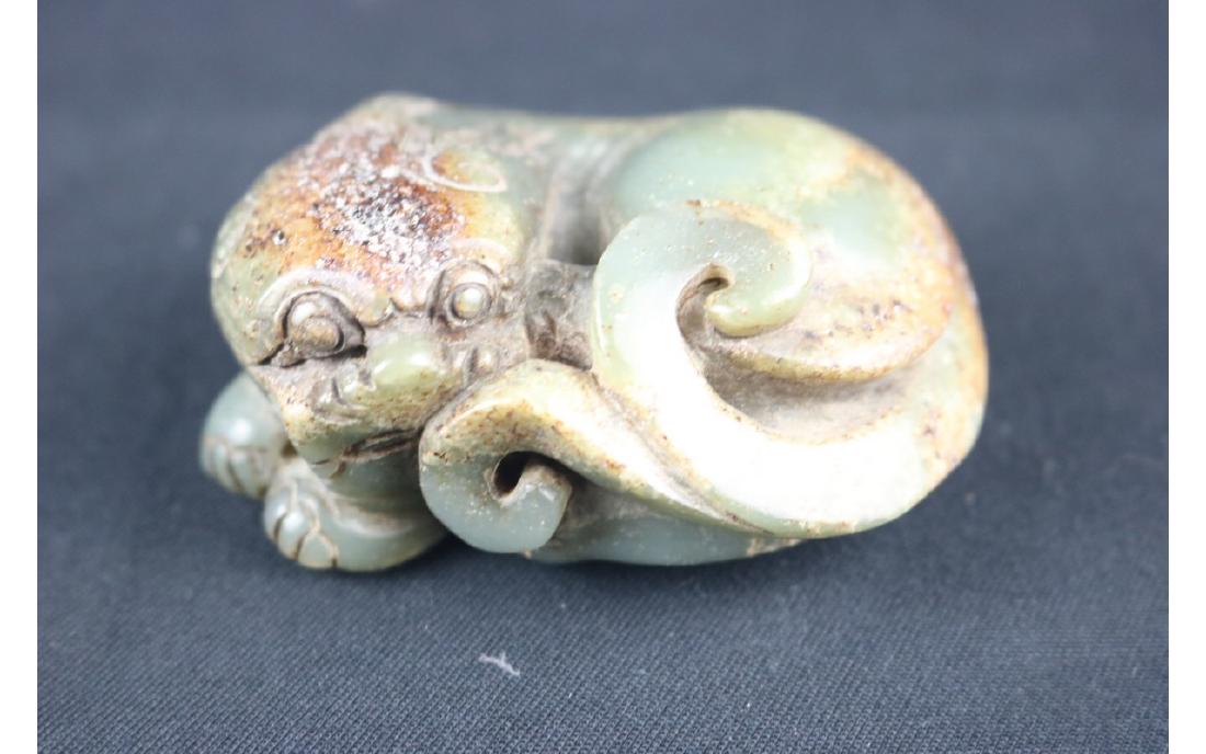 Chinese Jade Carved Lion: Chinese jade carved recumbant lion with legs tucked under body and head turned to one side; H: 3 cm, L: 8 cm, W: 6 cm