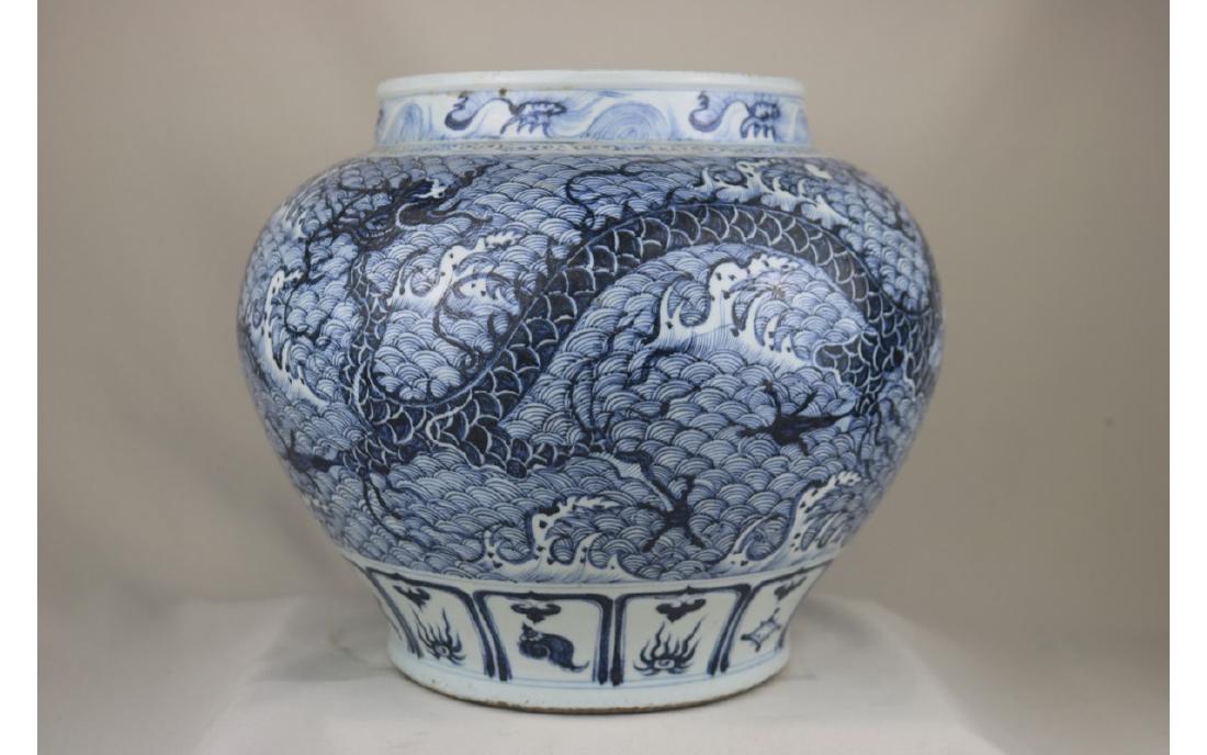 Chinese Blue and White Jar: Chinese blue and white porcelain jar; decorated with dragon surrounded by stormy waves; H: 28 cm, W: 34 cm