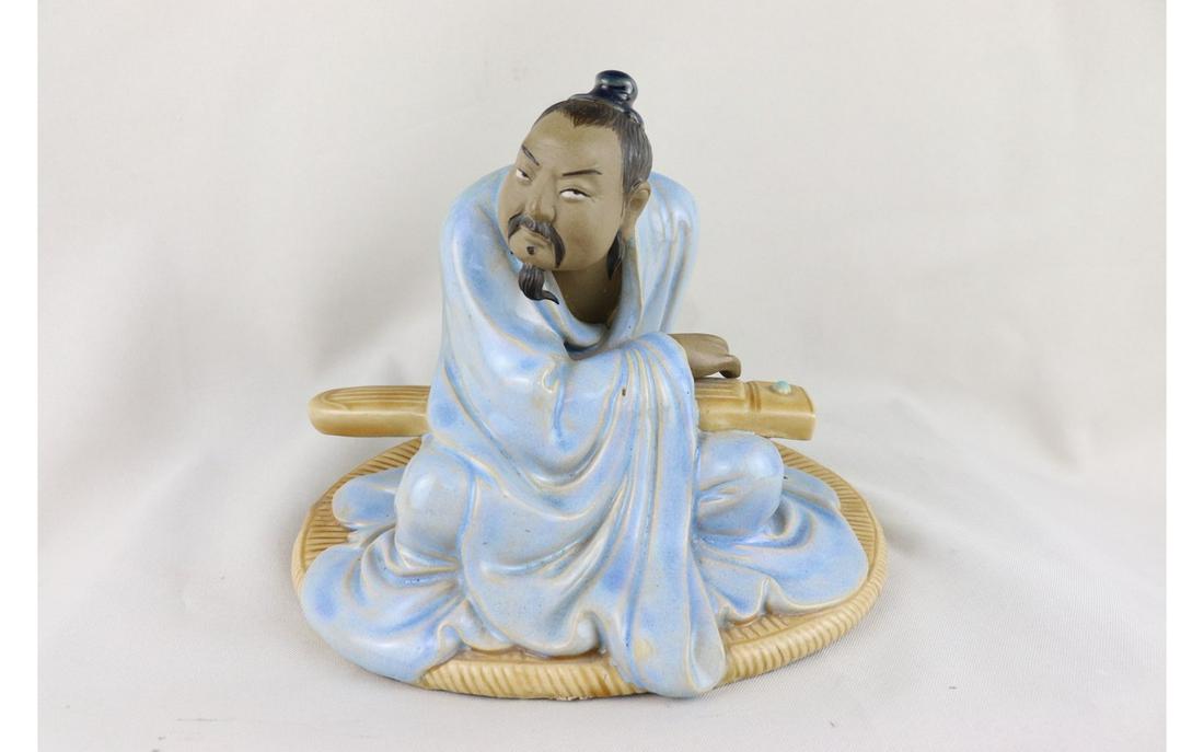 Chinese Famille Rose Porcelain Figure: Chinese Famille Rose Porcelain Figure, of sitting position, holding a guzheng on his arms, L 20 x W 19 x H 15 cm.
