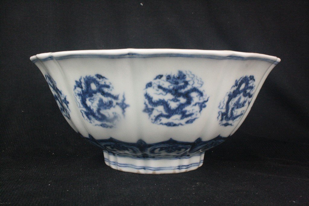 Chinese Blue and White Porcelain Bowl: Chinese blue and white porcelain bowl; of lotus floral shape; decorated with dragon; Xuande mark. H: 8.5 cm, W: 18.5 cm.