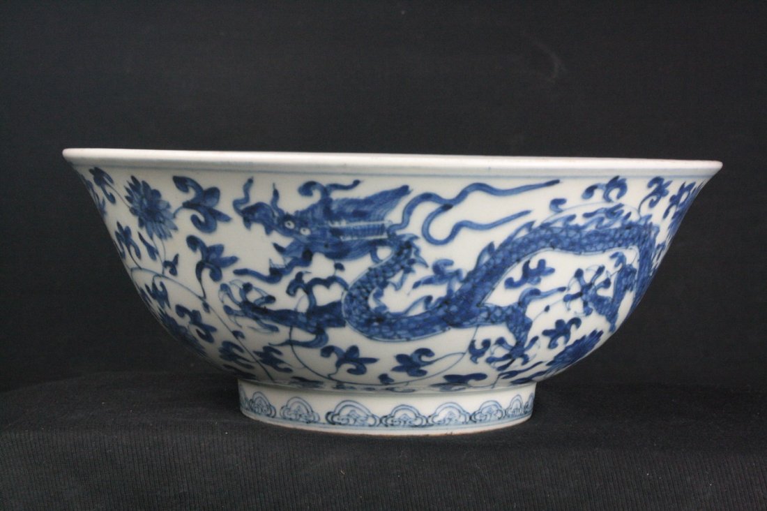 Chinese Blue and White Porcelain Bowl: Chinese blue and white porcelain bowl; painted with dragon surrounded by leafy lotus scrolls; four character Zhengde mark on base; H: 10.5 cm, D: 26.5 cm